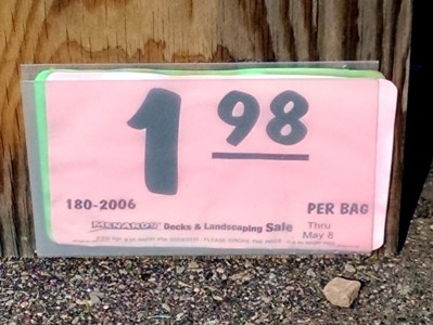 a pink sign with black numbers on it