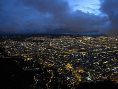 a city at night with clouds in the sky