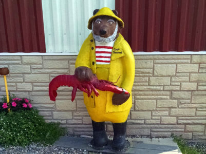 a statue of a bear holding a lobster